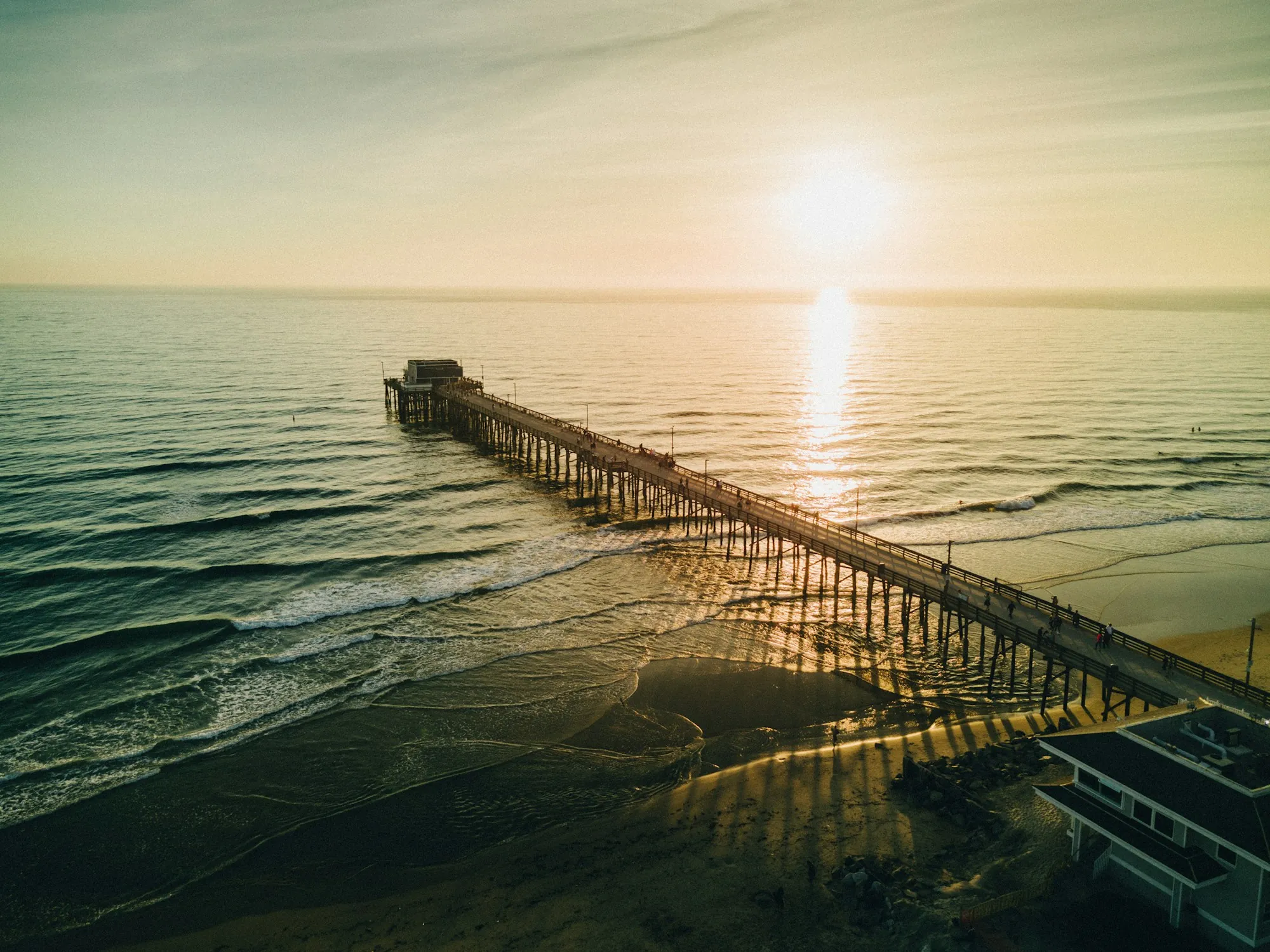 Find Out What Is Really in Your Water Ocean pier at sunset seen from above