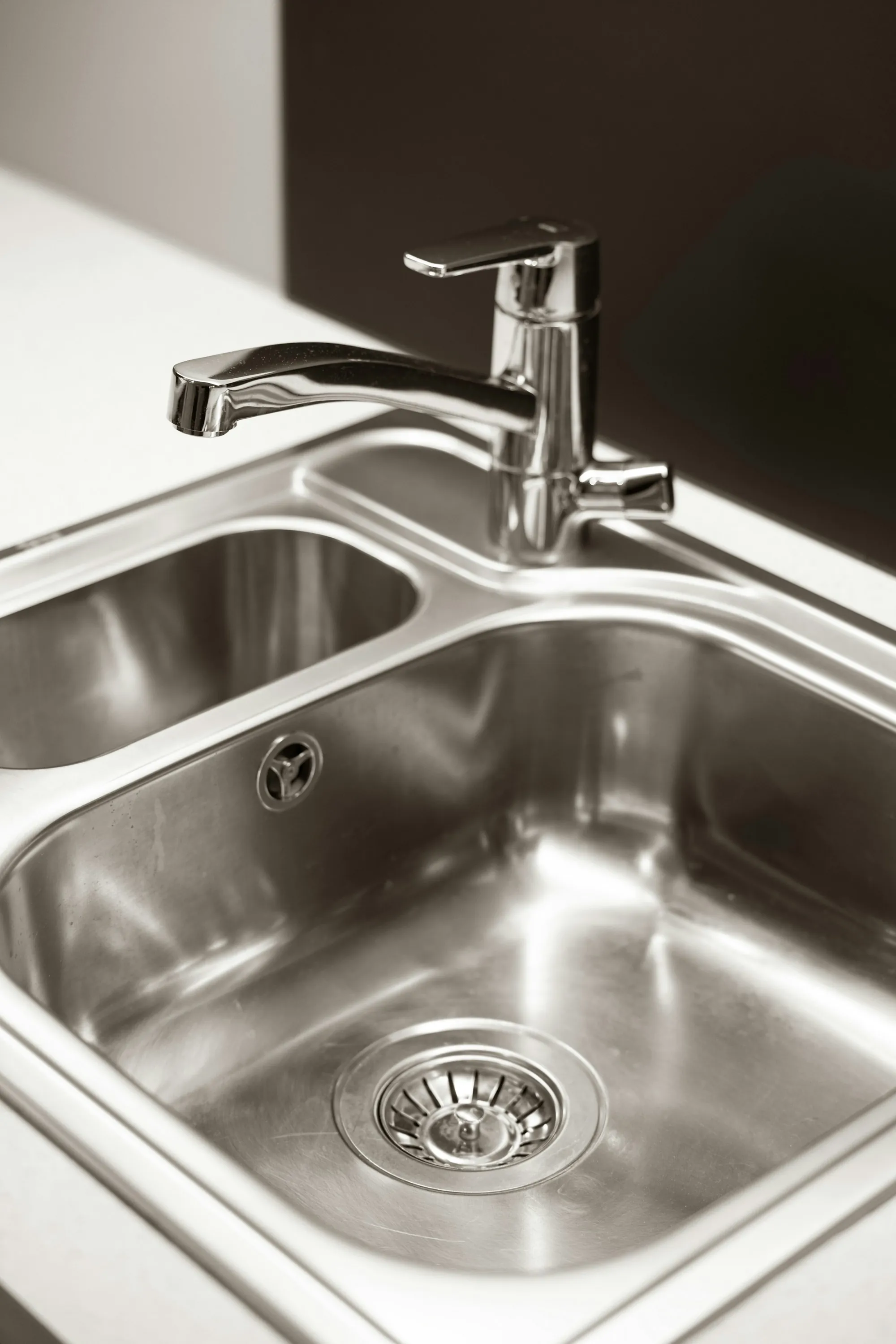 Water Softener Installation in Newport Beach Stainless steel kitchen sink with a chrome faucet