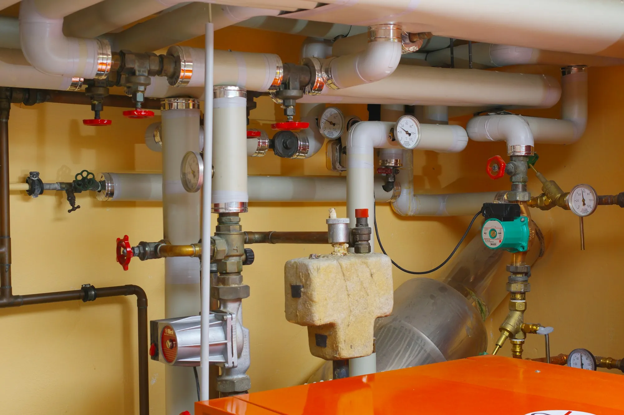 About Newport Beach Water Pros Water pipes and valves in a utility room