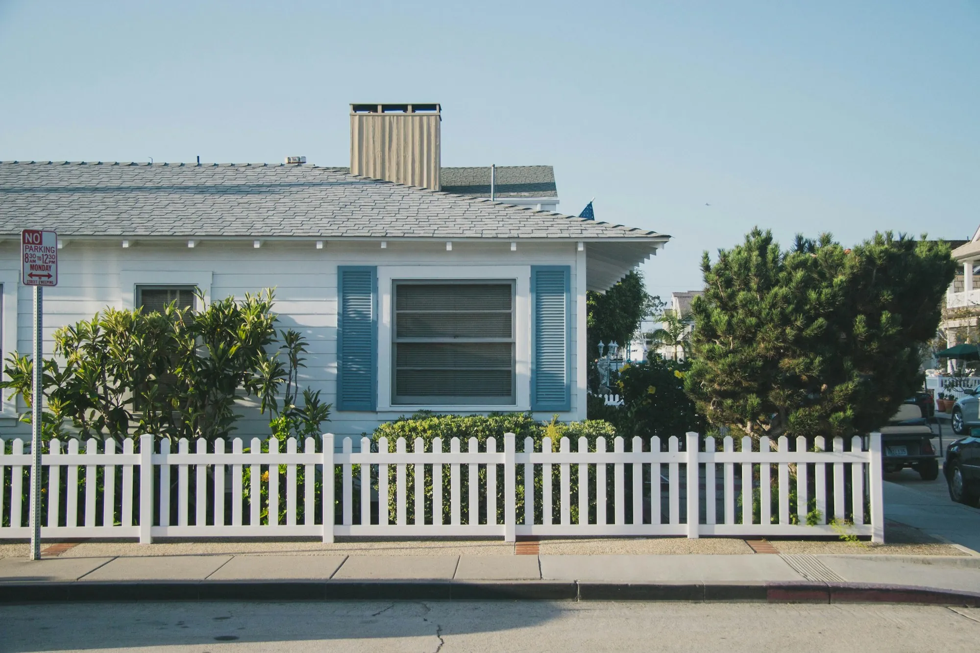 Contact Newport Beach Water Pros White and blue house behind a white picket fence