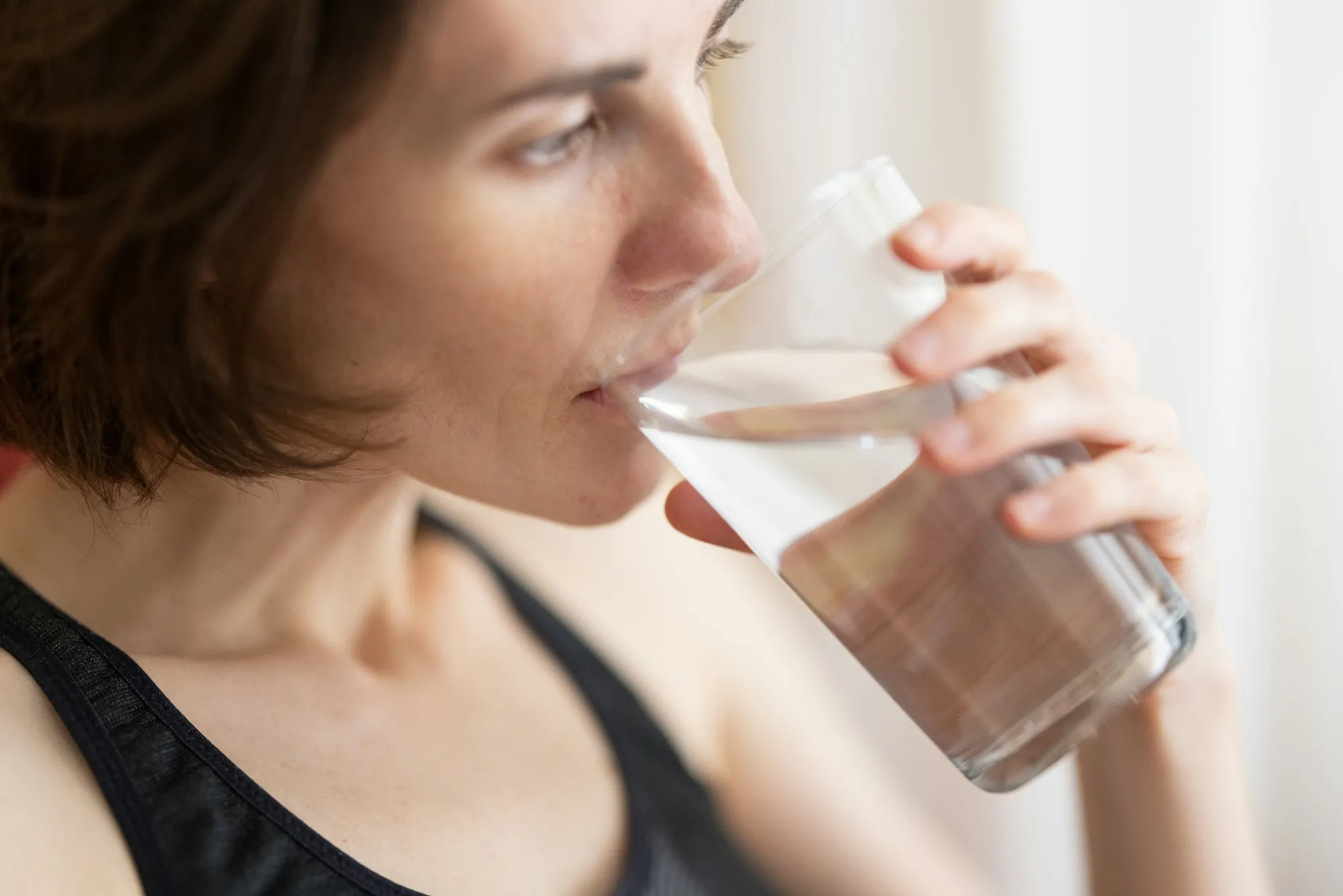 Reverse Osmosis Systems in Newport Beach Woman drinking a glass of water